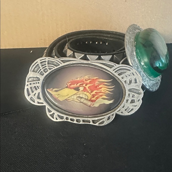 Two belt buckles and a studded belt